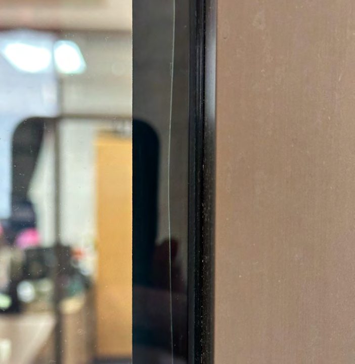 Hand-cut film, stopped short of the edge: Hand-cut edge, film well short of the glass edge.