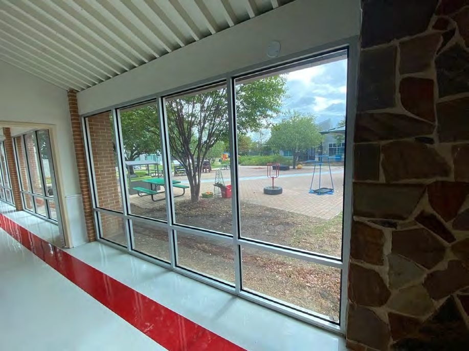 Texas elementary school corridor glass with 3M security film installed by Epic, playground beyond
